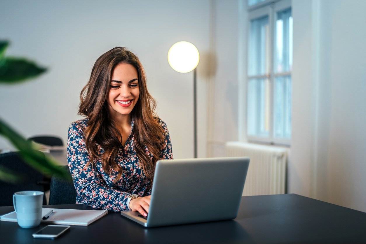 woman working on content promotion on laptop